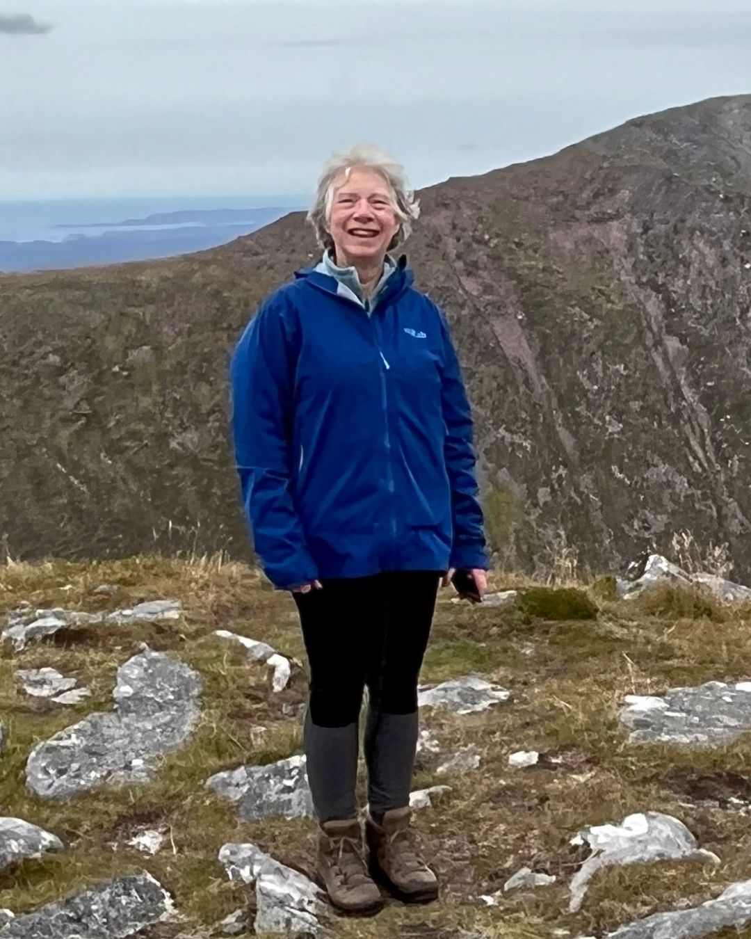 Sue smiling on a hillside